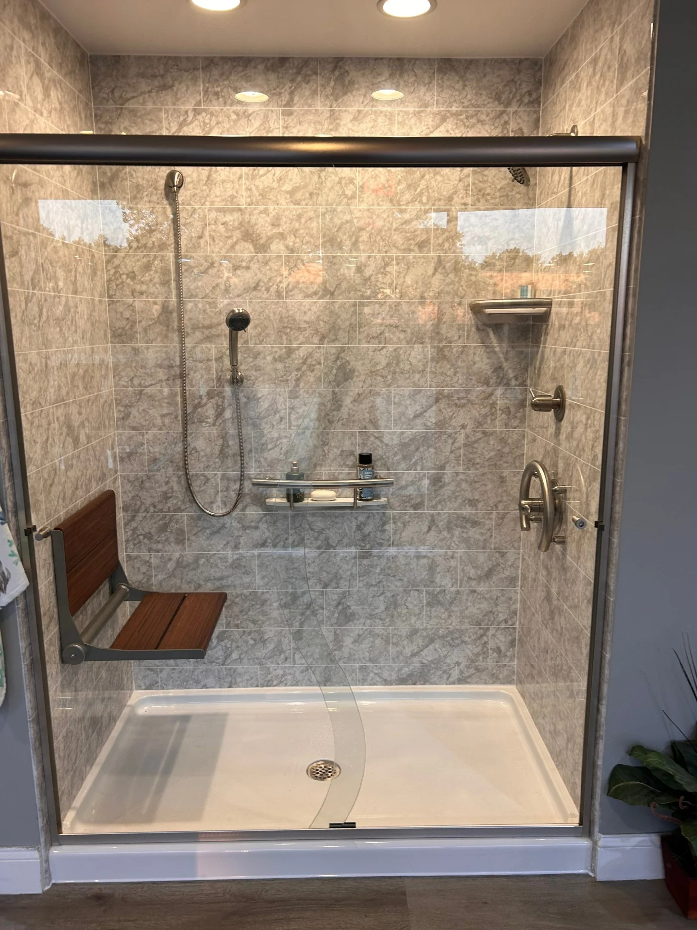 Walk-in shower with fold down deat and grab bars in Pembroke, MA