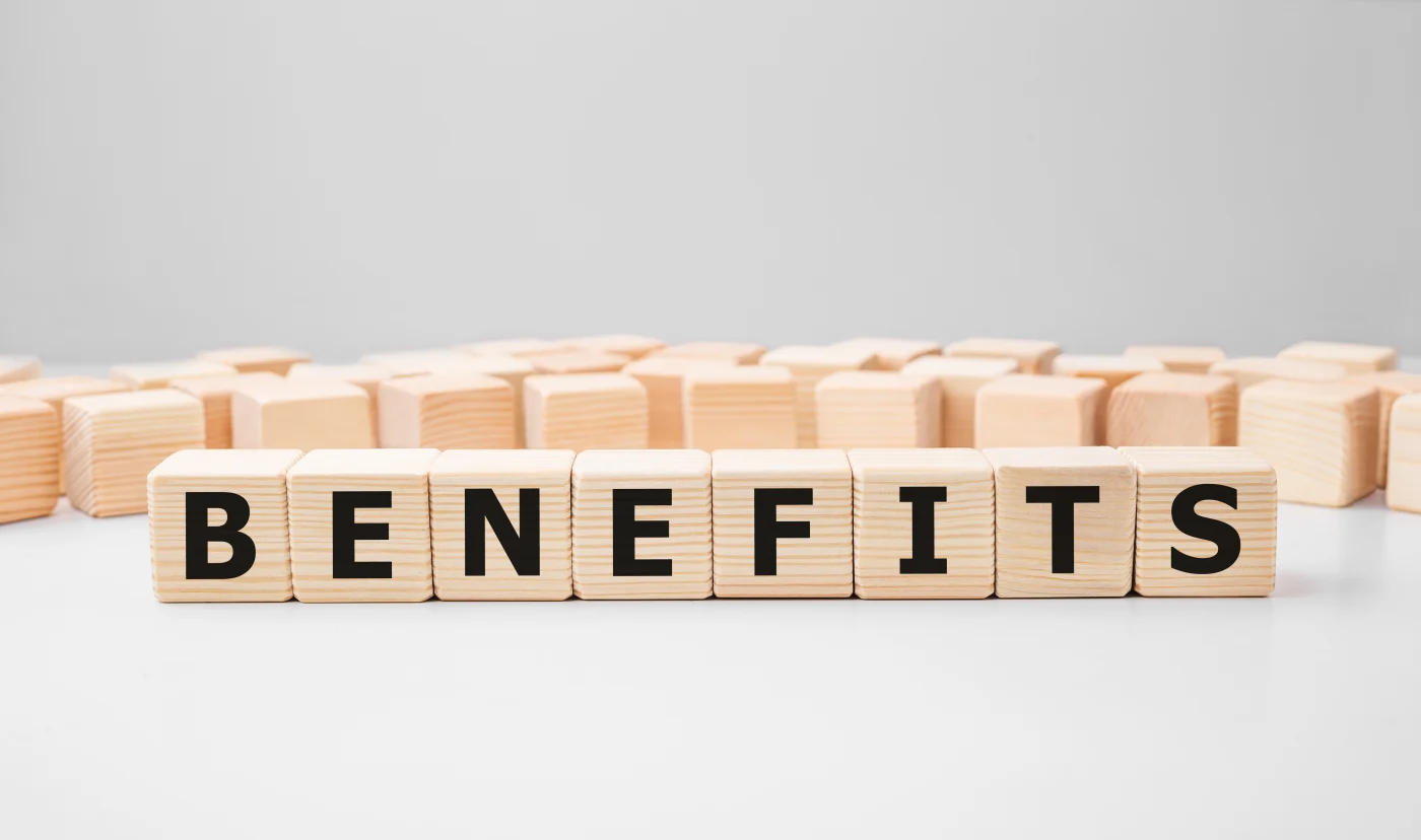 “Benefits” spelled out on wooden cubes on table
