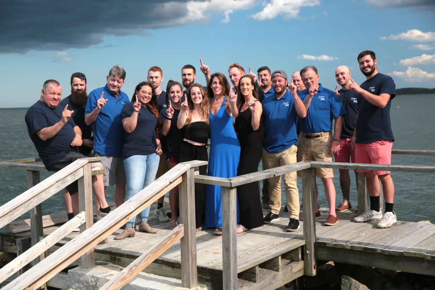 Bay State Bath employees hold up the #1 on dock