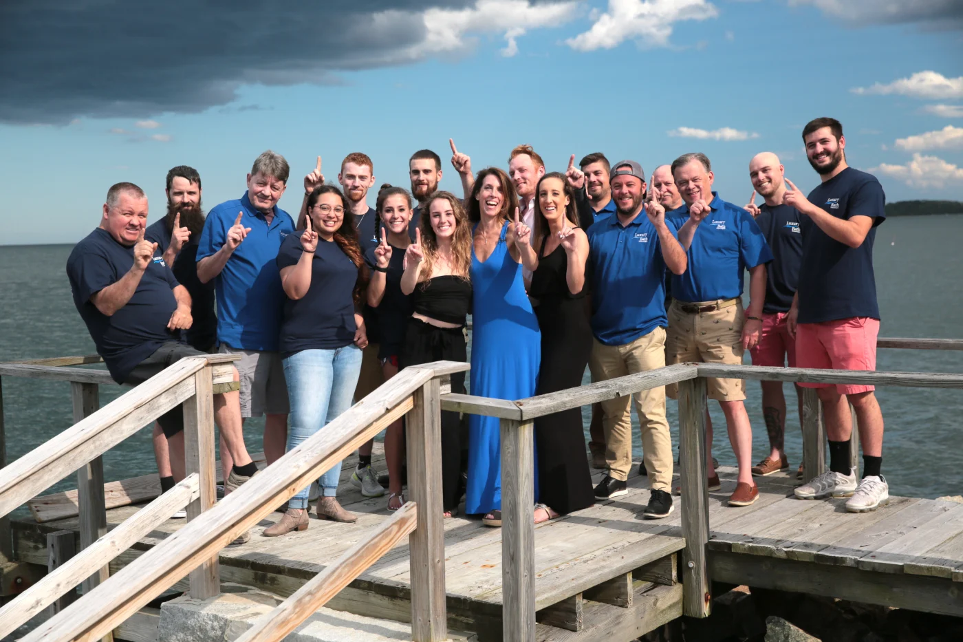 The smiling team at Bay State Bath is posing outside for a group shot