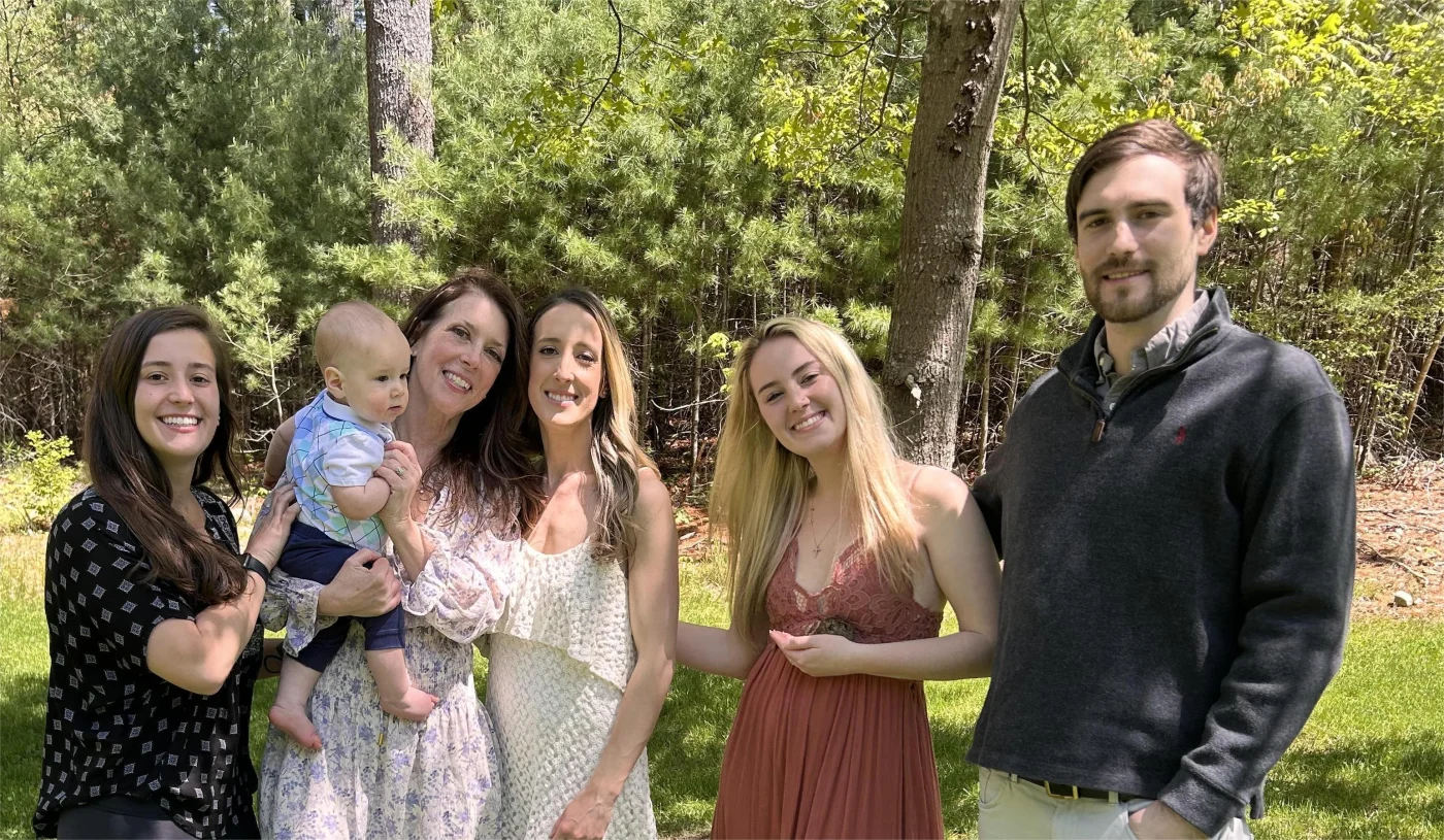 A family photo of the Bylo family in front of trees