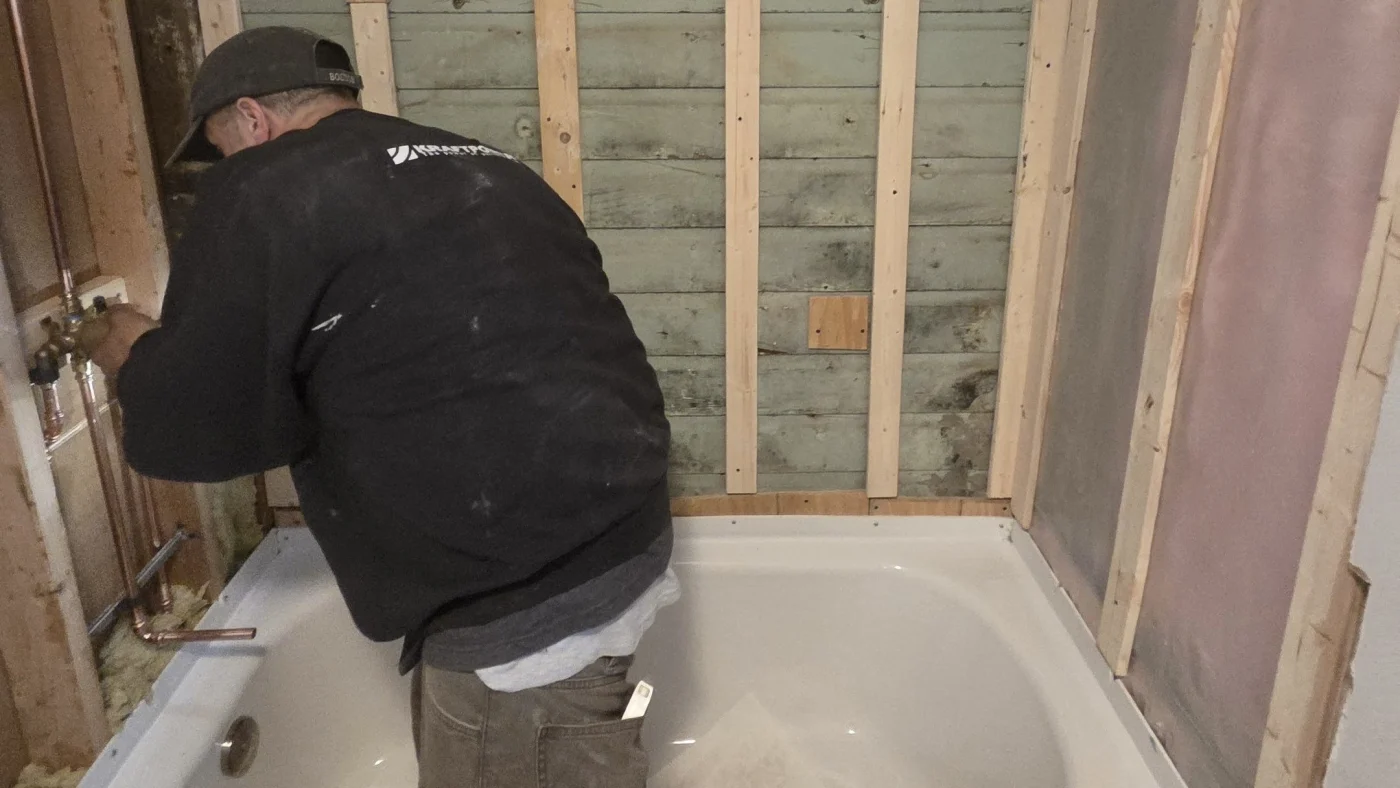 Master plumber from Bay State Bath works on bath remodel faucet in greater boston