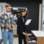Couple Choosing Bathroom Furniture In Home Improvement Showroom